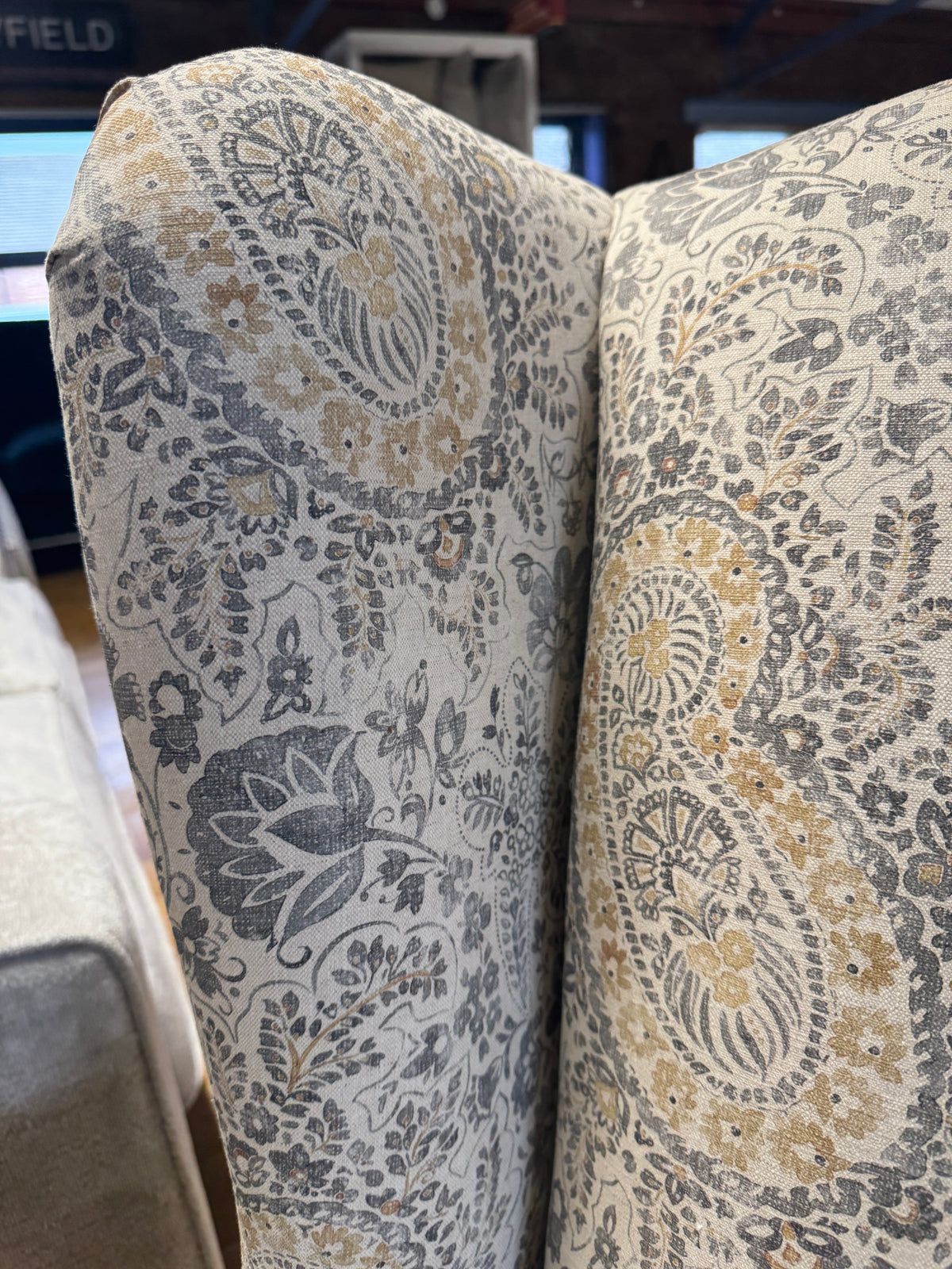 Heather wingback accent chair in grey / ochre Paisley print fabric