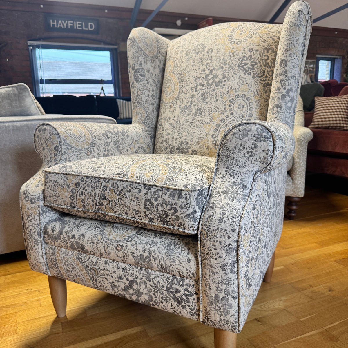 Heather wingback accent chair in grey / ochre Paisley print fabric