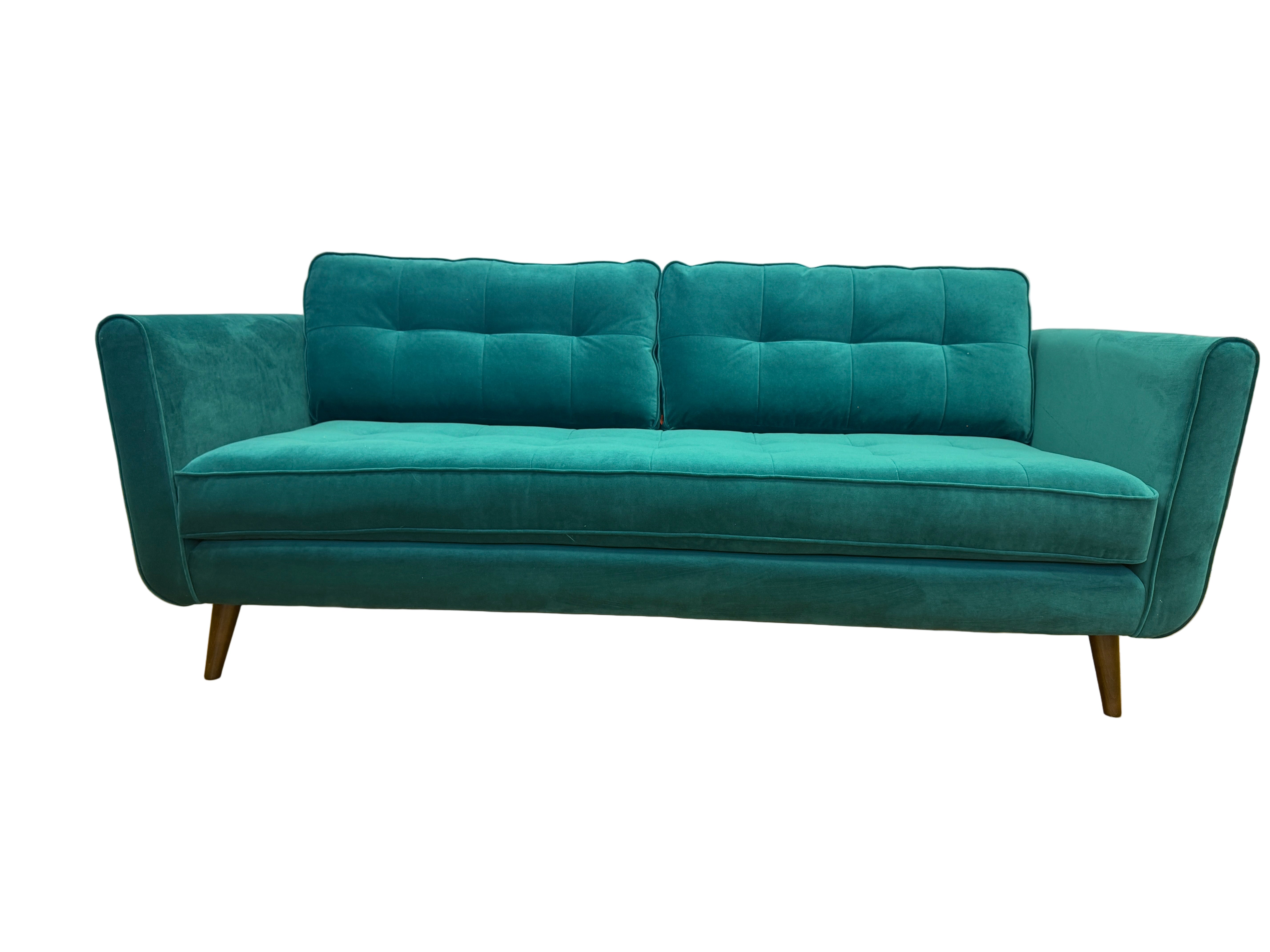 Teal sofa on a wooden floor with a white wall background